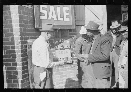 Untitled photo, possibly related to: Farmer buying patent medicine from salesman outside tobacco warehouse during auction sale. Durham, North Carolina