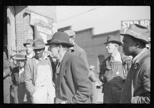 Untitled photo, possibly related to: Patent medicine salesman demonstrating his wares to farmers outside warehouse during tobacco auction sale. Durham, North Carolina