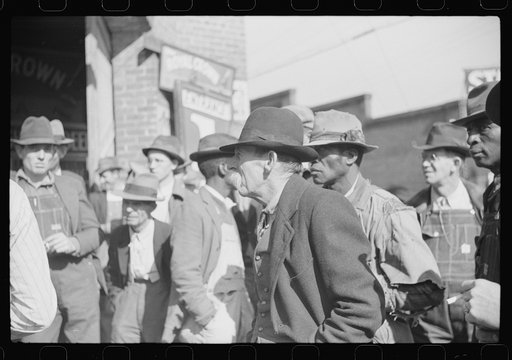Untitled photo, possibly related to: Patent medicine salesman demonstrating his wares to farmers outside warehouse during tobacco auction sale. Durham, North Carolina