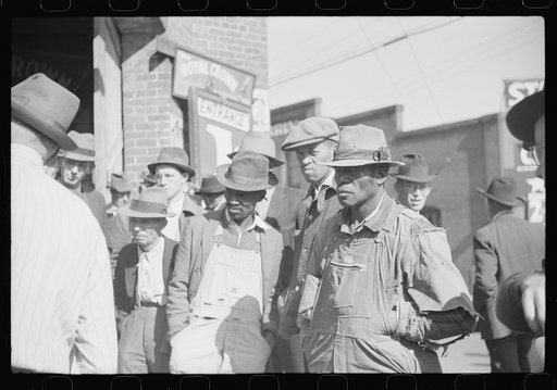 Untitled photo, possibly related to: Patent medicine salesman demonstrating his wares to farmers outside warehouse during tobacco auction sale. Durham, North Carolina