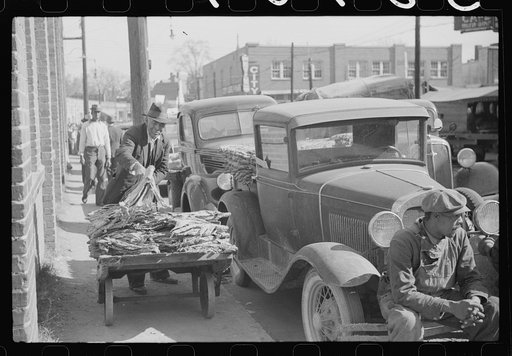 Untitled photo, possibly related to: Farmers bring their tobacco in trailers and sometimes in their cars to the warehouse where it will be auctioned. Durham, North Carolina
