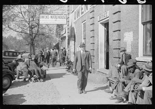 Farmers waiting outside warehouse before tobacco auction sale. Oxford, North Carolina