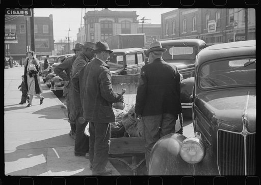 Untitled photo, possibly related to: Farmers waiting around outside warehouse before tobacco auction sale.  Tobacco was brought in trailer to warehouse. Oxford, North Carolina
