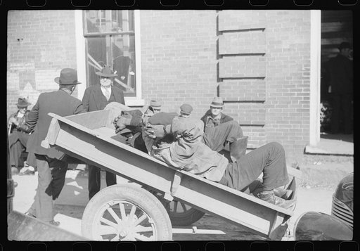 Untitled photo, possibly related to: Very often farmers must travel long distances at night or wait several days for tobacco to be sold. They can be found sleeping on the covered piles of tobacco in warehouses or in their trucks or the floors of camp rooms. Durham, North Carolina