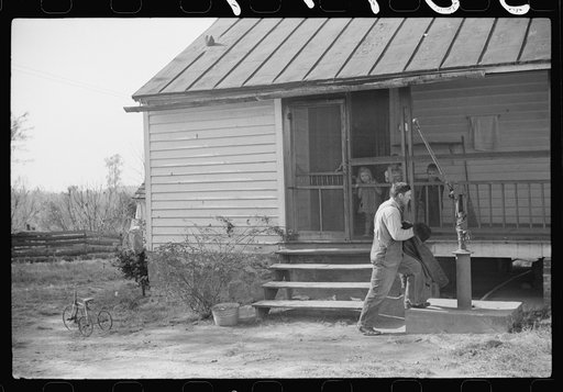 One of the men who helped with corn shucking at the Fred Wilkins place, getting ready to "wash up" before dinner. Tally Ho, near Stem, Granville County, North Carolina
