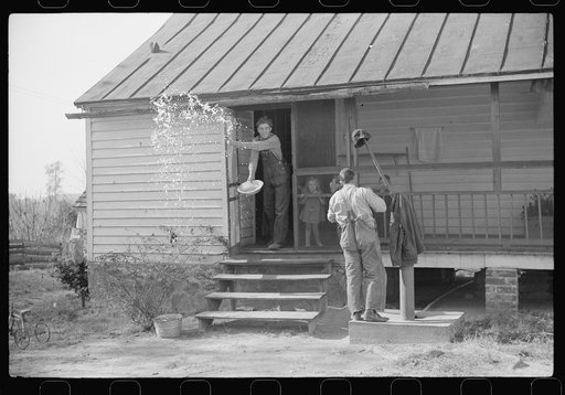 Men who were helping with corn shucking going into house to wash up before dinner. Fred Wilkins farm. Tally Ho, near Stem, Granville County, North Carolina