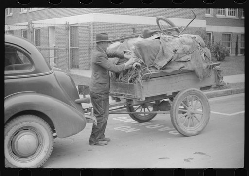 Untitled photo, possibly related to: Mr. Wilkins with trailer full of tobacco which he has brought to be auctioned at warehouse. On top of load is his son's bicycle which he brought to town to be repaired. Durham, North Carolina