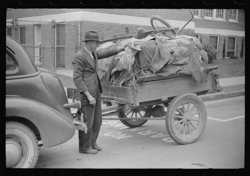Untitled photo, possibly related to: Mr. Wilkins with trailer full of tobacco which he has brought to be auctioned at warehouse. On top of load is his son's bicycle which he brought to town to be repaired. Durham, North Carolina