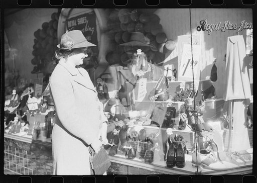 Mrs. Evan Wilkins (Rosa) looking in shop window. She came to Durham this day with her husband to sell their tobacco at auction and do some general shopping. Durham, North Carolina