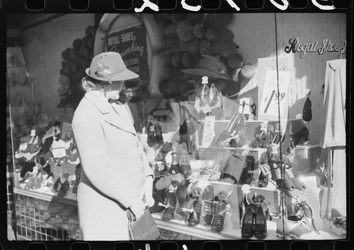 Untitled photo, possibly related to: Mrs. Evan Wilkins (Rosa) looking in shop window. She came to Durham this day with her husband to sell their tobacco at auction and do some general shopping. Durham, North Carolina