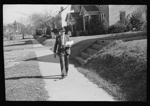 Mr. Evan Wilkins with butter he is selling which was made on his farm.  Durham, North Carolina