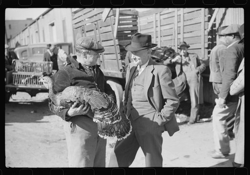 Untitled photo, possibly related to: Farmer talking with with another farmer who has just purchased a turkey. Outside tobacco warehouse where auction sales are being held. Durham, North Carolina