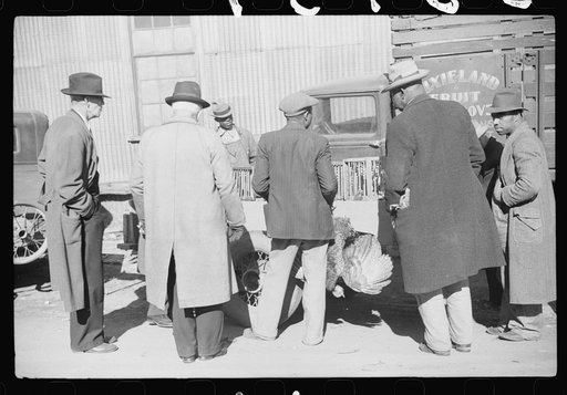 Untitled photo, possibly related to: Farmer selling Thanksgiving turkey to farmer outside warehouse where tobacco auction sales are being held. Durham, North Carolina