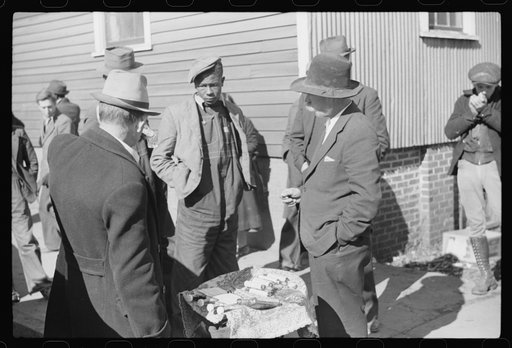 Untitled photo, possibly related to: Salesman displaying patent medicine to farmers who have brought tobacco to warehouse and are waiting outside for the sales to begin. Mebane, North Carolina