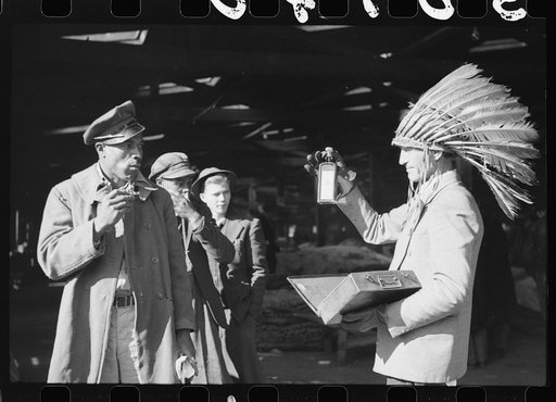 Patent medicine salesman waiting for farmers, outside tobacco warehouse where auction sales are being held. Durham, North Carolina