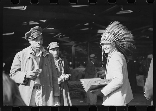 Untitled photo, possibly related to: Patent medicine salesman waiting for farmers, outside tobacco warehouse where auction sales are being held. Durham, North Carolina