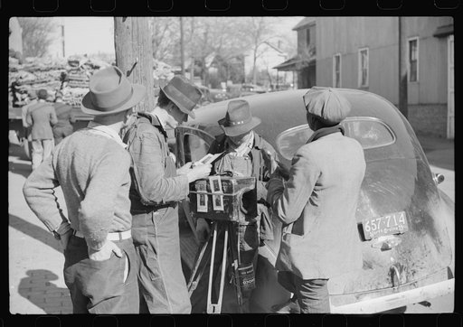 Traveling photographer making a sale outside warehouse where tobacco auctions are being held. Durham, North Carolina