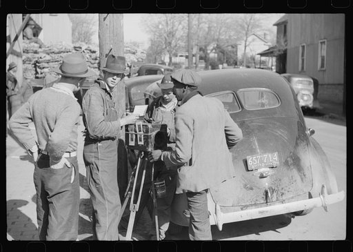 Untitled photo, possibly related to: Traveling photographer making a sale outside warehouse where tobacco auctions are being held. Durham, North Carolina