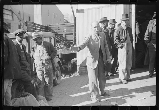 Itinerant preacher spreading "religion" to farmers outside warehouse while tobacco auction sales are going on. Durham, North Carolina