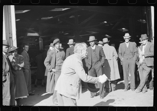 Itinerant preacher spreading "religion" to farmers outside warehouse while tobacco auction sales are going on. Durham, North Carolina