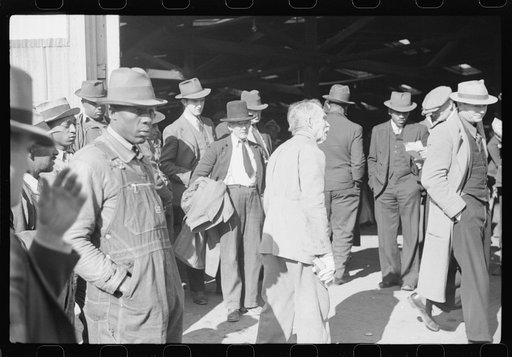 Itinerant preacher spreading "religion" to farmers outside warehouse while tobacco auction sales are going on. Durham, North Carolina