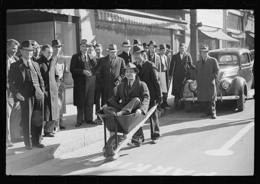 Tobacco auctioneer who "bet on Carolina" and lost, pays off the wager by pushing the warehouseman in a wheelbarrow from the warehouse to the courthouse. Durham, North Carolina