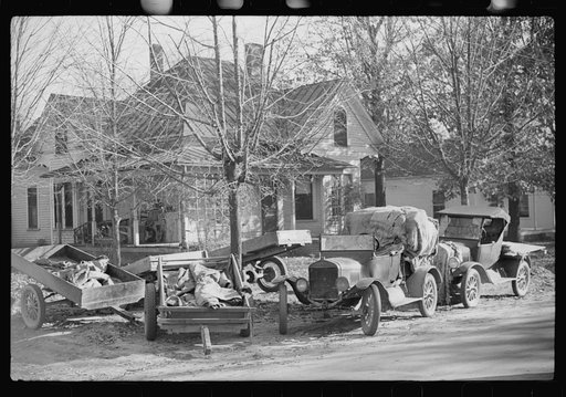 Untitled photo, possibly related to: Trailers and cars belonging to farmers. They bring their tobacco for auction in all kinds of conveyances. Outside warehouse. Mebane, North Carolina