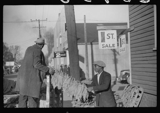 Untitled photo, possibly related to: Farmers arranging their tobacco on baskets preparatory to taking them to warehouse. It was full before the sale and there was no room to unload the tobacco. Mebane, North Carolina