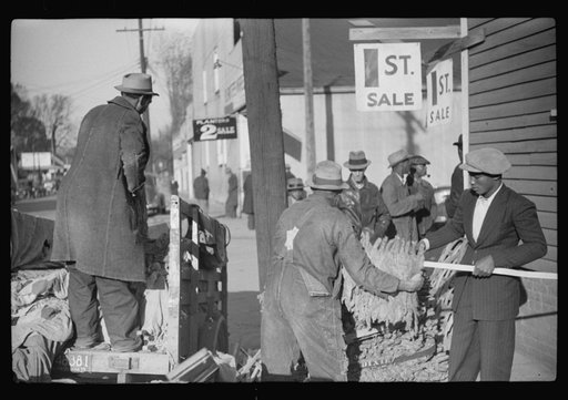 Untitled photo, possibly related to: Farmers arranging their tobacco on baskets preparatory to taking them to warehouse. It was full before the sale and there was no room to unload the tobacco. Mebane, North Carolina