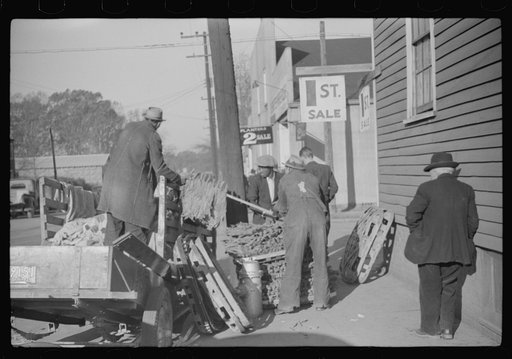 Untitled photo, possibly related to: Farmers arranging their tobacco on baskets preparatory to taking them to warehouse. It was full before the sale and there was no room to unload the tobacco. Mebane, North Carolina