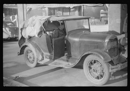 Untitled photo, possibly related to: Cars belonging to farmers loaded with tobacco which is being brought to warehouse for auction sale. Mebane, North Carolina