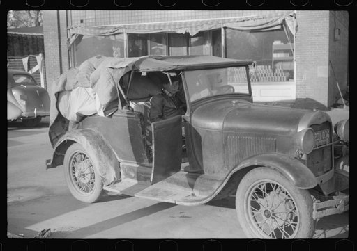 Cars belonging to farmers loaded with tobacco which is being brought to warehouse for auction sale. Mebane, North Carolina