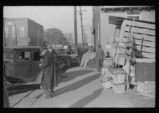 Untitled photo, possibly related to: Farmers and warehousemen unloading tobacco on sidewalk, before auction sale. The warehouse was too overloaded to permit more tobacco being brought in. Mebane, North Carolina