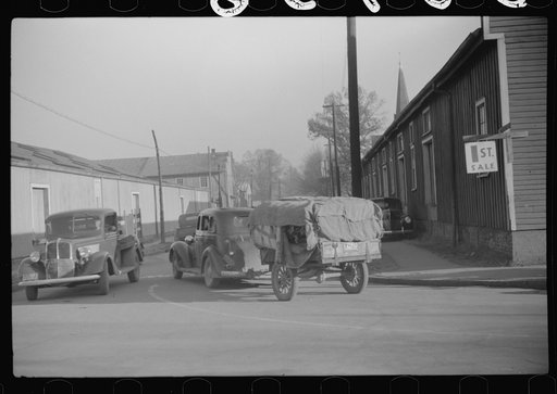 Untitled photo, possibly related to: Cars belonging to farmers loaded with tobacco which is being brought to warehouse for auction sale. Mebane, North Carolina