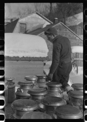 Untitled photo, possibly related to: Farmers near Woodstock, Vermont, bring their cans of milk to the crossroads early every morning where it is picked up by the coop farmers' truck and is taken to the city