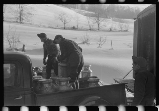 Untitled photo, possibly related to: Farmers near Woodstock, Vermont, bring their cans of milk to the crossroads early every morning where it is picked up by the coop farmers' truck and is taken to the city