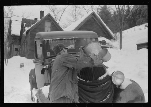 Untitled photo, possibly related to: Hired man on farm near Woodstock, Vermont, usually empties the radiator in his car every evening and refills it again with water in the morning to save the cost of antifreeze