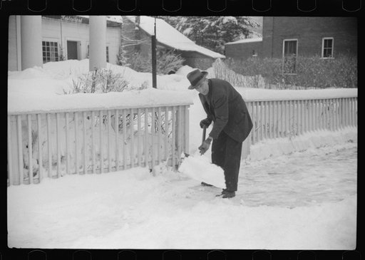 Untitled photo, possibly related to: Clearing off the sidewalk after the snowstorm in front of White Cupboard Inn, Woodstock, Vermont