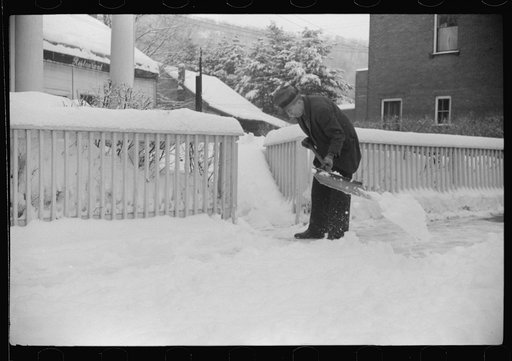 Clearing off the sidewalk after the snowstorm in front of White Cupboard Inn, Woodstock, Vermont