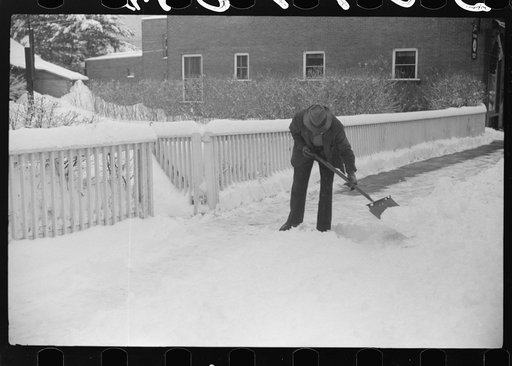 Untitled photo, possibly related to: Clearing off the sidewalk after the snowstorm in front of White Cupboard Inn, Woodstock, Vermont