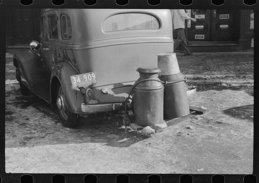 Rear view of farmer's car in center of town, Woodstock, Vermont. Water is hauled since the usual supply has been frozen