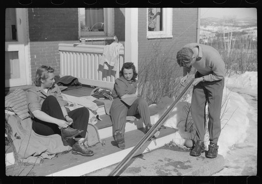 Skiers on porch of Mr. Dickinson's home in Lisbon, Franconia, New Hampshire. He installed a ski tow on his property three years ago costing around one thousand dollars, and this is the first year he has made any money on it, but business is increasing rapidly now. He has a small dairy farm and until
