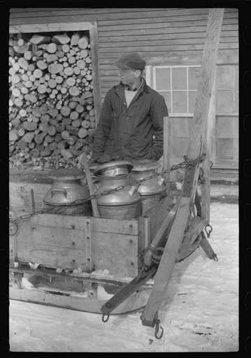 Hauling water in milk cans because usual source of supply is frozen. Putney Homestead farm near Woodstock, Vermont