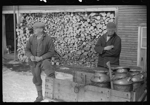 Untitled photo, possibly related to: Hauling water in milk cans because usual source of supply is frozen. Putney Homestead farm near Woodstock, Vermont