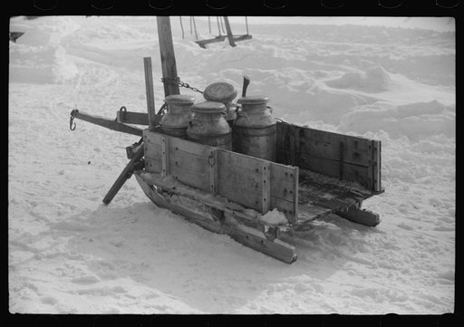 Untitled photo, possibly related to: Hauling water in milk cans because usual source of supply is frozen. Putney Homestead farm near Woodstock, Vermont