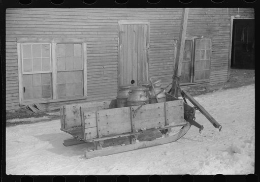 Untitled photo, possibly related to: Hauling water in milk cans because usual source of supply is frozen. Putney Homestead farm near Woodstock, Vermont