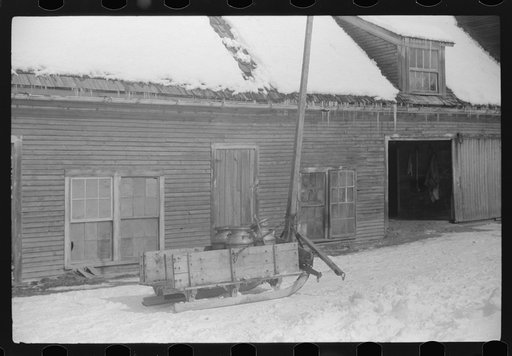 Hauling water in milk cans because usual source of supply is frozen on Putney Homestead near Woodstock, Vermont