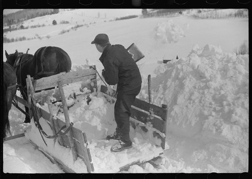 Untitled photo, possibly related to: Hauling water in milk cans because usual source of supply is frozen. Putney Homestead farm near Woodstock, Vermont