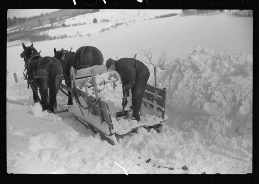 Untitled photo, possibly related to: Hauling water in milk cans because usual source of supply is frozen. Putney Homestead farm near Woodstock, Vermont