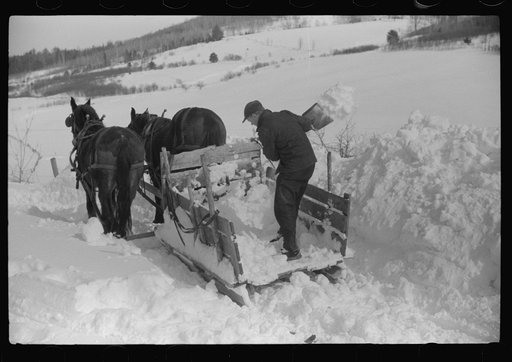 Untitled photo, possibly related to: Hauling water in milk cans because usual source of supply is frozen. Putney Homestead farm near Woodstock, Vermont